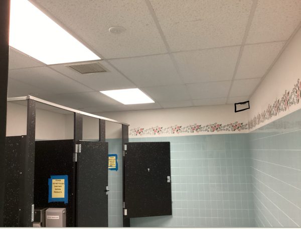 Vape detectors go in the corner of the bathroom like the black box drawn on the wall or is on the ceiling where you see the white circle above. Many districts are opting to use detectors.  