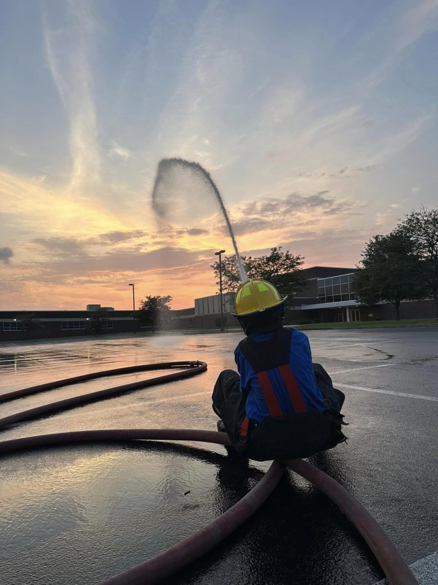 A Dewey fire-fighting-junior practicing using a the hose.  The department is always looking for new volunteers.