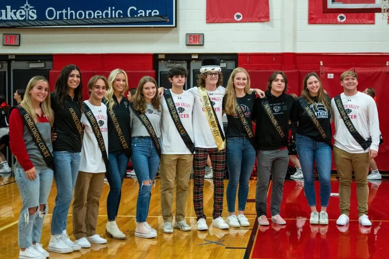 The homecoming court of 2022 poses for photos at the community pep rally. These students are recognized by the school community following the announcement of the homecoming king. 
