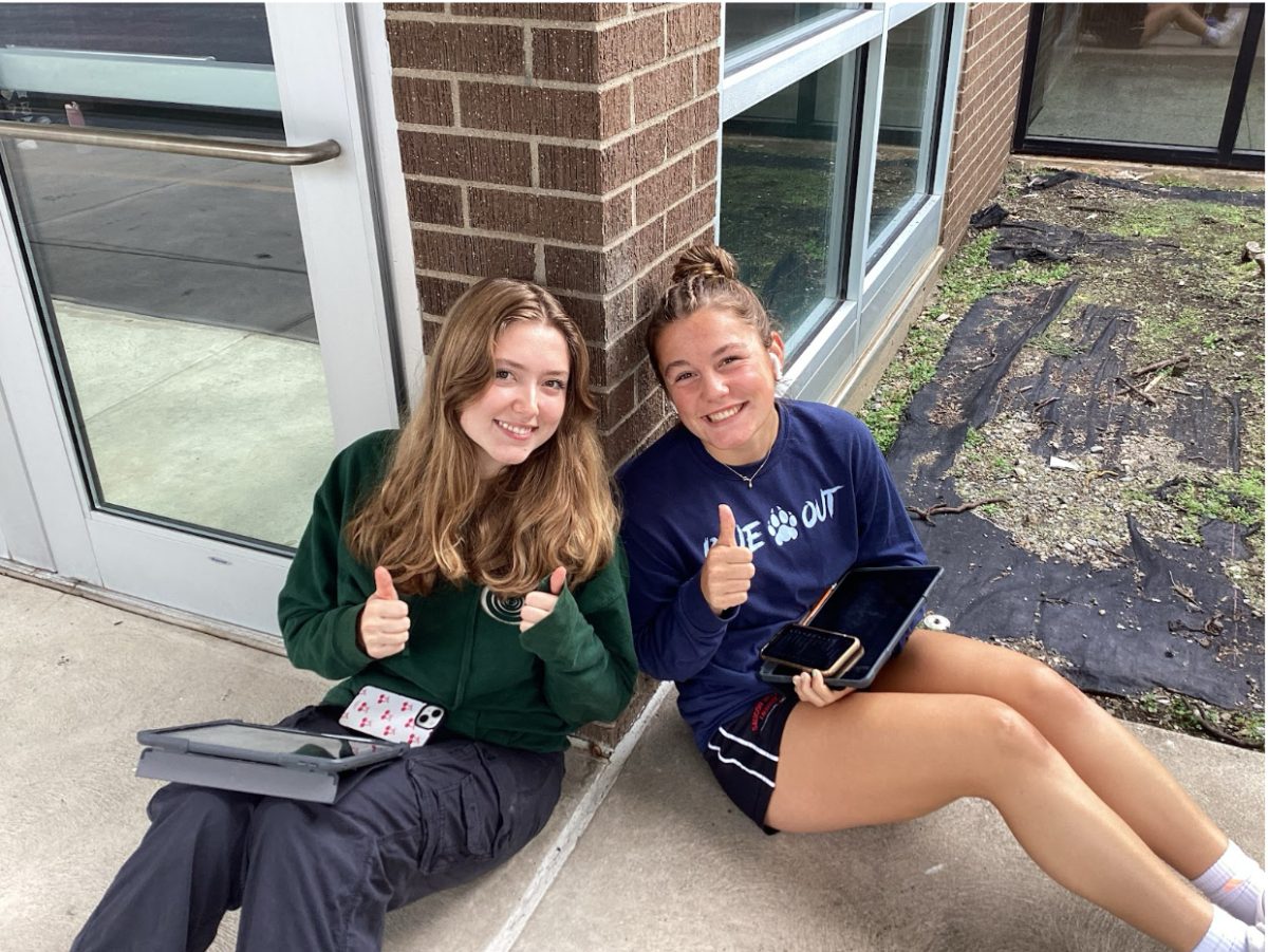 Seniors Sophia Kosh (left) and Arianna Renninger (right) sit outside the school. As seniors, they have learned many lessons in high school, ranging from academic ones to personal growth.