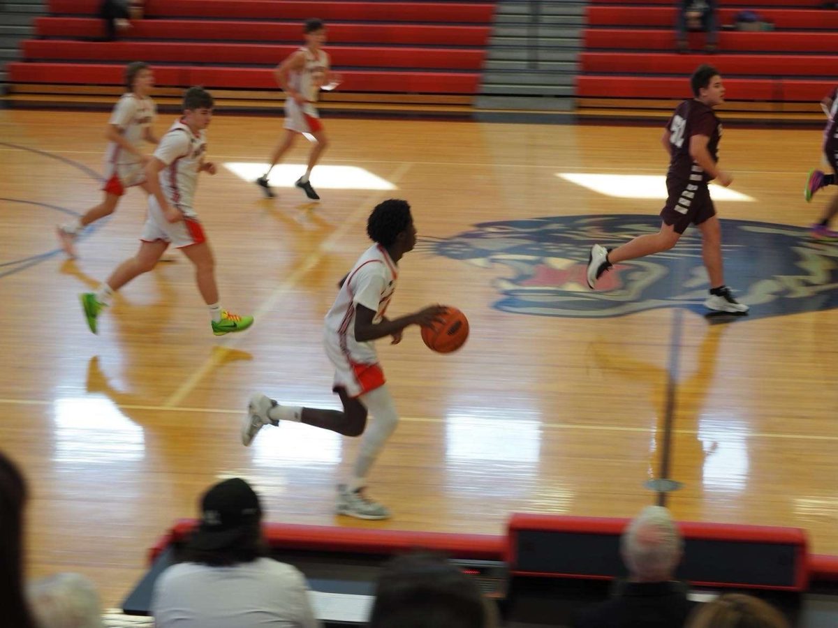 Isaac drives down the side of the court for a layup. This was in his 8th grade season.