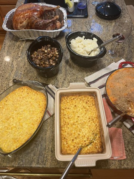 Above are some of the common foods that can be found at a Thanksgiving dinner. Included in the photo is corn casserole, stuffing, turkey, mashed potatoes, and sweet potatoes.