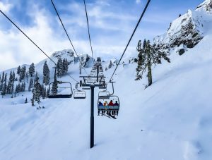 Four person carriage lift in a winter landscape. With Winter approaching, many wonder what is the best place to ski this season.
