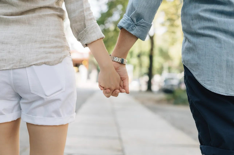 Two people holding hands. Studies show that most people go on 10-20 first dates before they find their soulmate.
