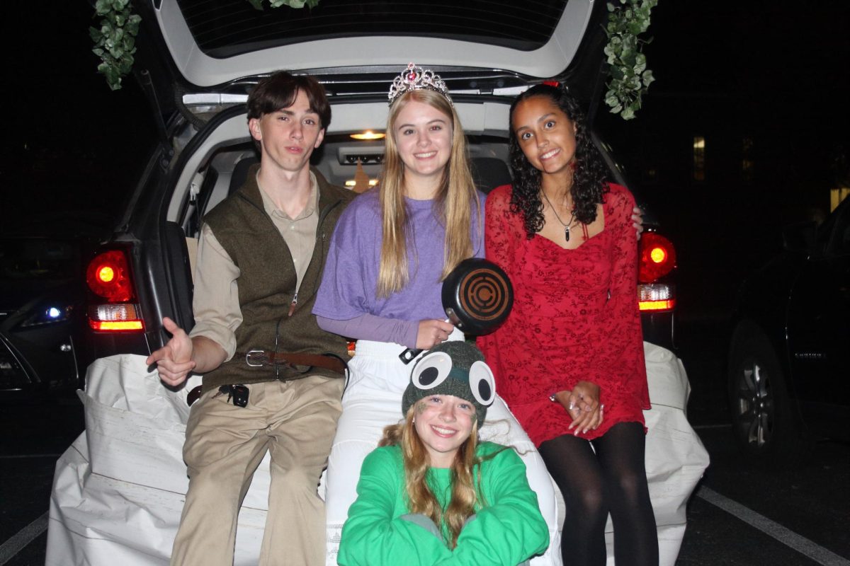 Juniors David Fleck, Elliot Policare, Janiah Welsh and senior Ava Reihl pose with their Tangled inspired costumes and trunk.