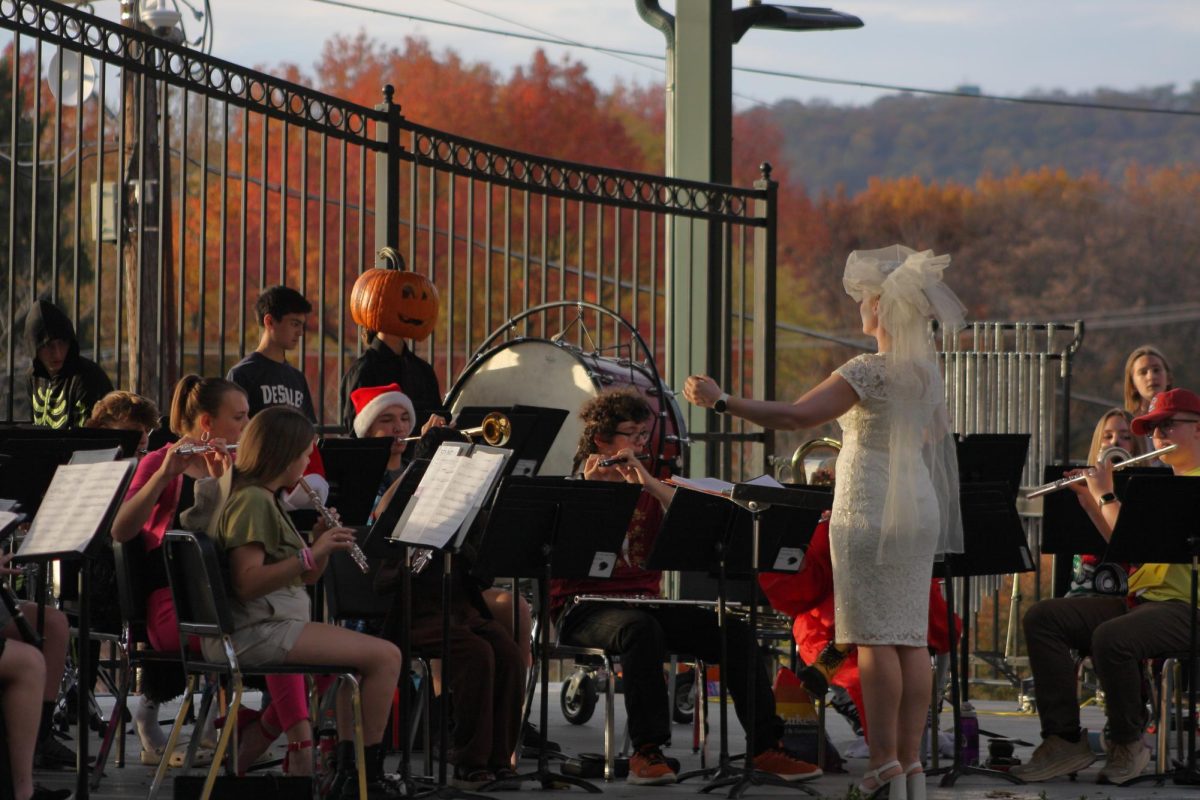 Band conductor and music teacher Ms. Bitting composing the Halloween Festival at Dimmick Park.