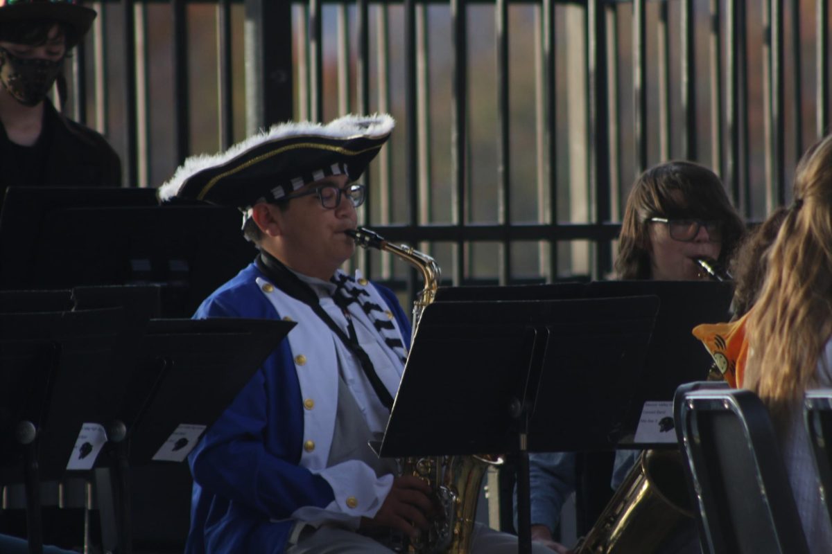 Freshman Brennan Nepomuceno preforming his saxophone at the Halloween Festival at Dimmick Park.