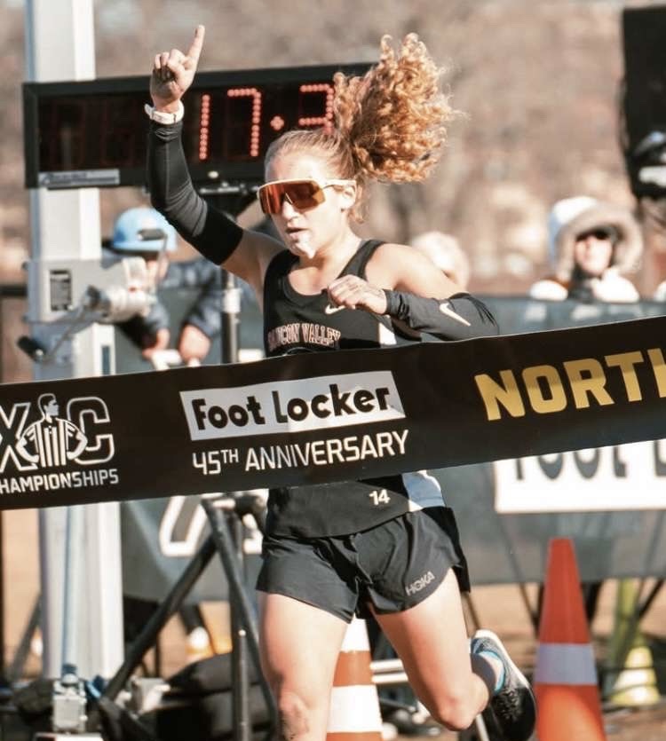 Kraus crossing the finish line of the Foot Locker Northeast Regionals. She finished with a time of 17:34.4.
