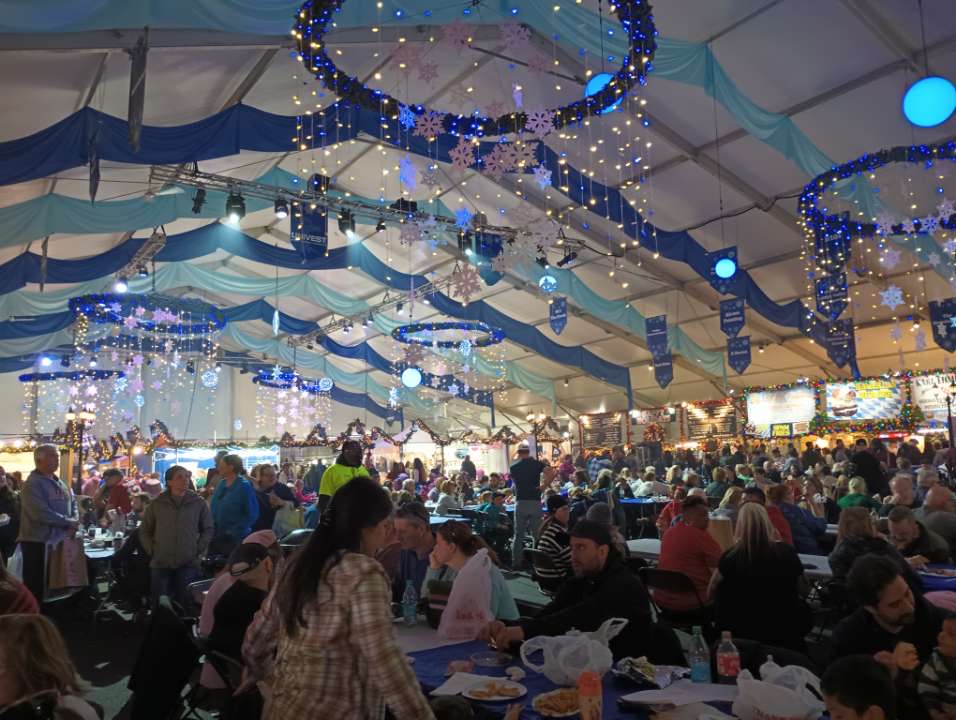 Inside shot of the christkindlmarket food area featuring many German cuisine.