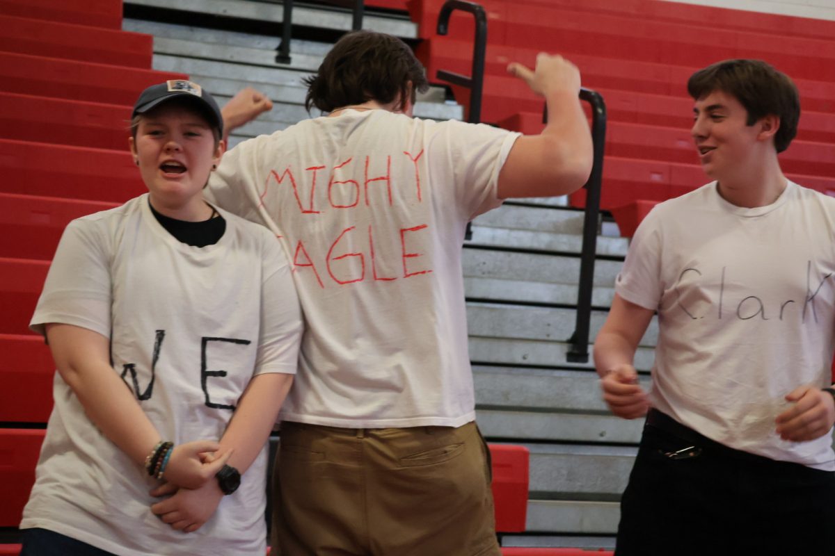 Group of students sporting their merch for the “Mighty Eagle” Senior Adam Clark.