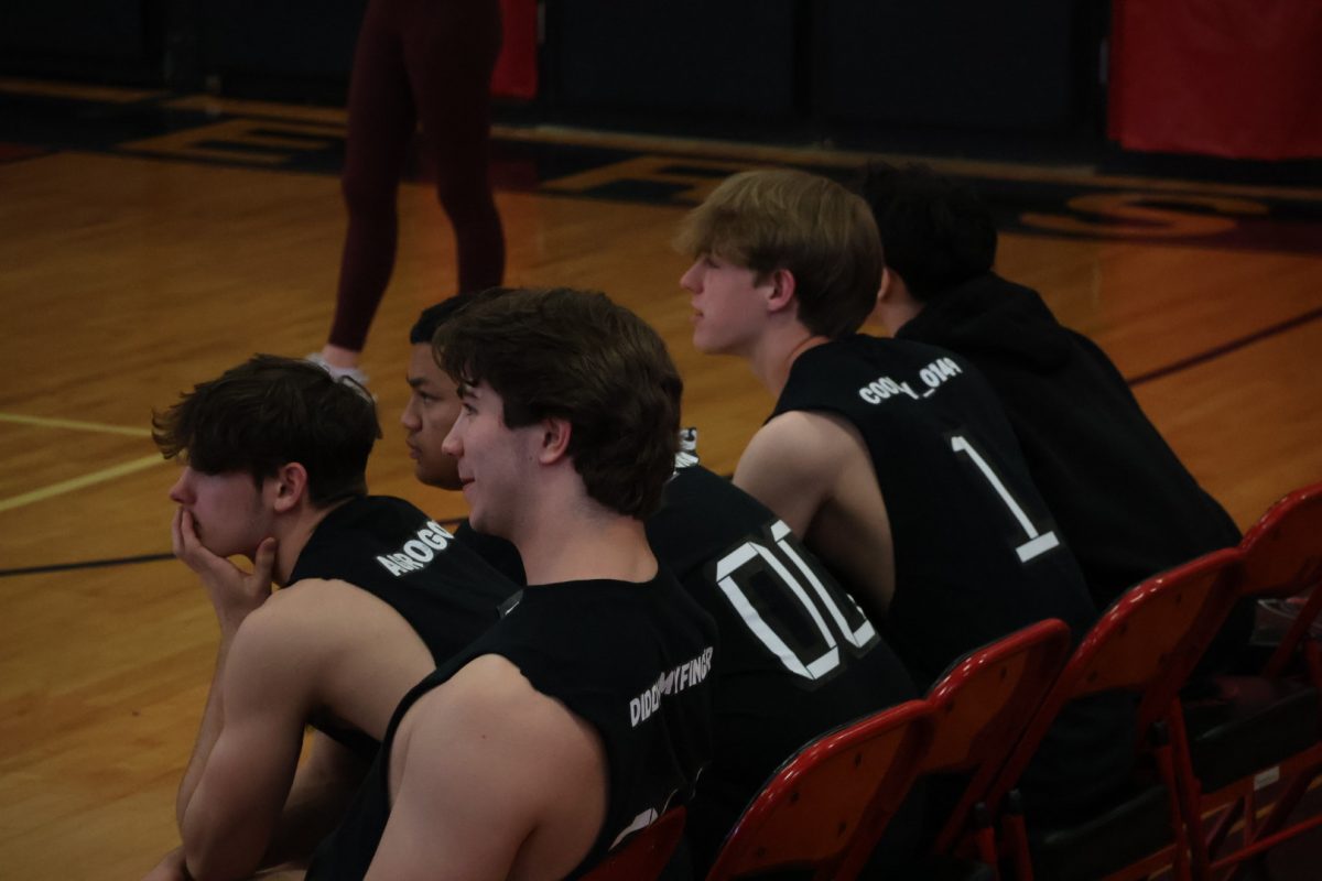 Group of players sitting on the bench.