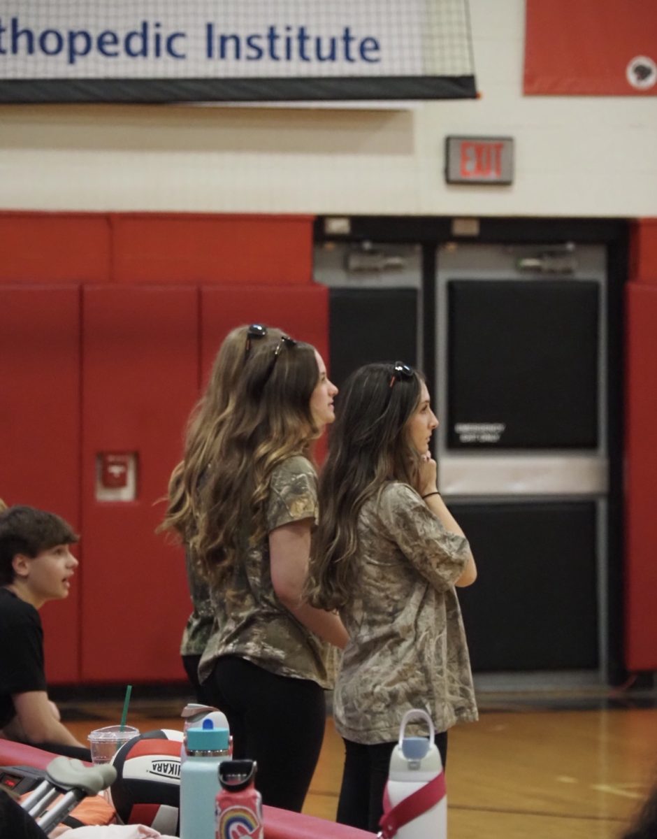Powderpuff coaches watch their team play.